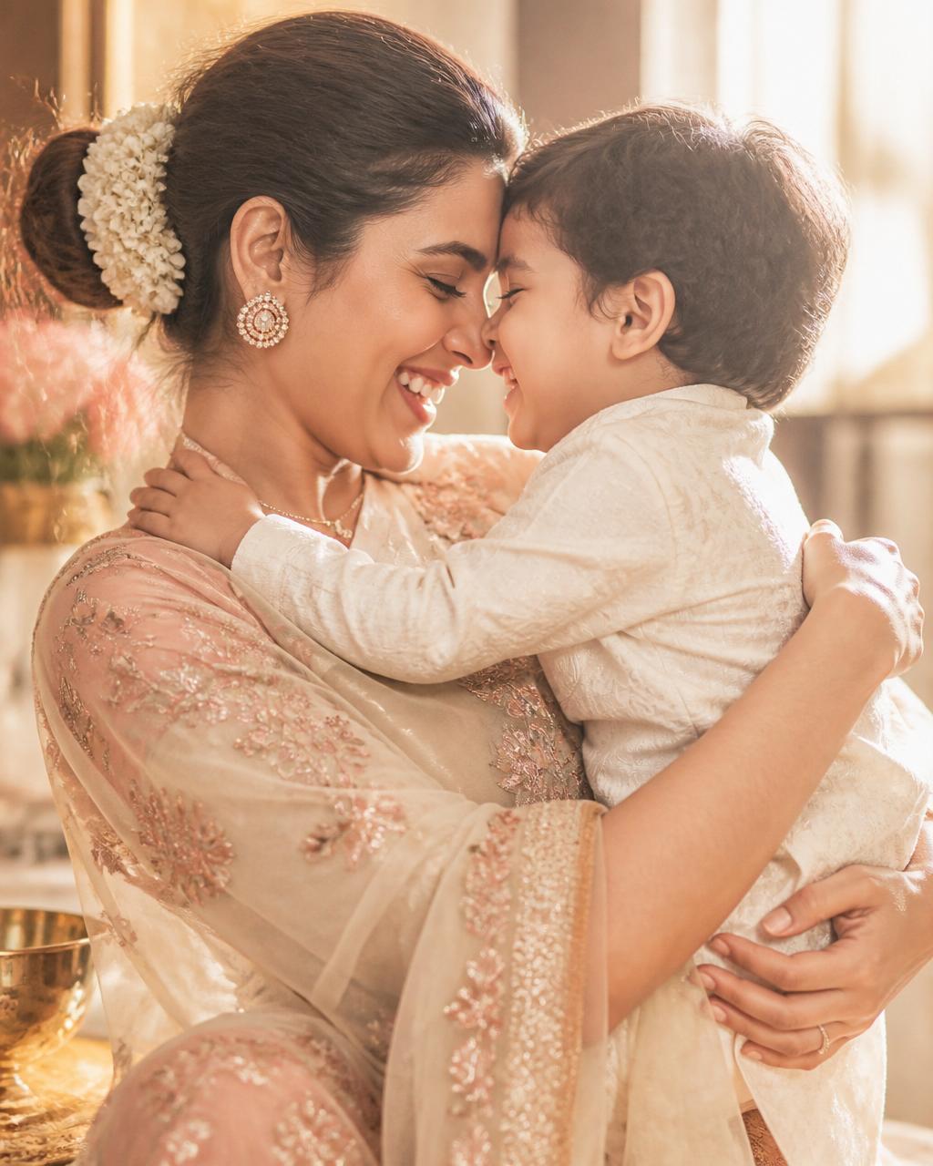 A radiant, happy mother hugging her child, foreheads touching